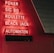 Red neon letters are mounted on a dark tiled wall, displaying the words Poker, Sic Bo, Roulette, Black Jack, and Automaten.